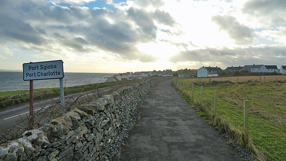 Picture of a coastal village at the end of a coastal path, a sea loch visible on the left