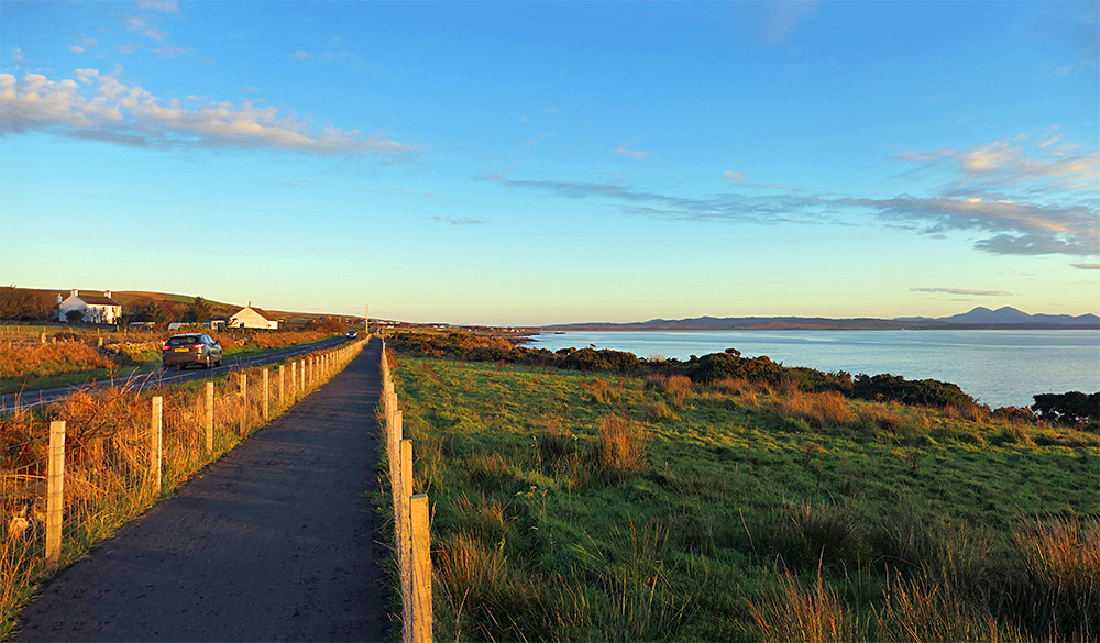 Picture of a view along a coastal path at a sea loch in some beautiful mild sunrise light from the right
