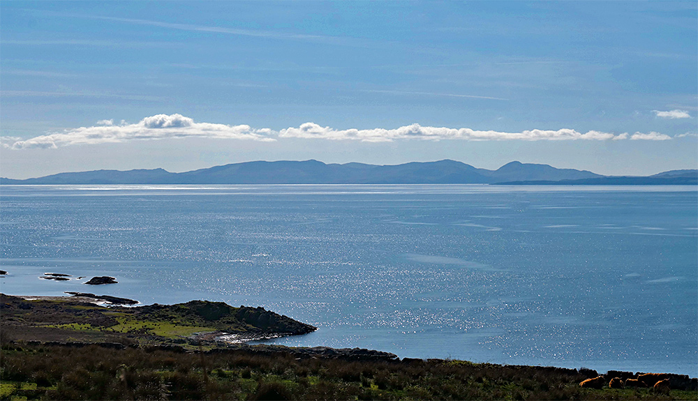 Picture of an island seen across the sea from the mainland on a sunny April day